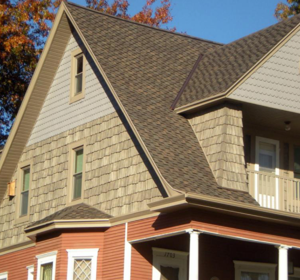 Scalloped and jagged/hand-cut style shake shingles accenting clapboard 